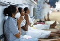 Anuradhapura, Sri Lanka - 03 30 2021: Buddhist devotees praying at the Ruwanwelimahasaya, wearing a protective face mask while