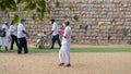 Anuradhapura, Sri Lanka - 03 31 2021: Old lady in a wheelchair with flower offerings and her son takes her mother to Jaya Sri Maha