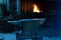 The anvil in the forge against the background of the forge in which the fire burns Royalty Free Stock Photo