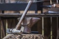 Anvil, hammer and mace displayed over cork oak stump