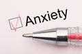 Anxiety - checkbox with a tick on white paper with pen. Checklist concept