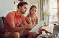 Anxiety, debt and stress with a couple paying bills on a laptop, checking their budget and savings. Young husband and Royalty Free Stock Photo