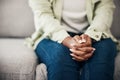 Anxiety, hands and woman on a sofa with stress, fear or worry for mental health or domestic abuse in her home Royalty Free Stock Photo