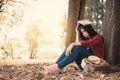 Anxiety woman about her studying sitting lonely under the big tree on park Royalty Free Stock Photo