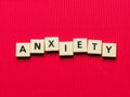 ANXIETY word made from square letter tiles on red background. Royalty Free Stock Photo