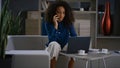 African american businesswoman discuss financial report by cell phone in office. Royalty Free Stock Photo