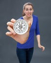 Anxious beautiful young woman panicking, holding a large compass