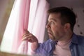 Anxious caucaisian man feel nervous pessimistic look at window wait for someone Royalty Free Stock Photo