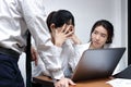 Anxious depressed young Asian business women are being blamed with boss in workplace.