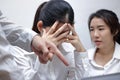 Anxious depressed young Asian business women are being blamed with boss in workplace.