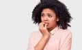 Anxious fearfull African American young woman keeps hand near mouth, feels frightened and scared Royalty Free Stock Photo