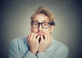 Anxious man biting his fingernails craving for something Royalty Free Stock Photo