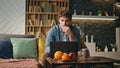 Anxious man looking laptop drinking coffee home late evening. Tired freelancer Royalty Free Stock Photo