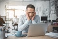 Anxious man looking at laptop