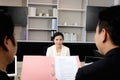 Anxious nervous candidate woman has interview for new job by two businessman managers, giving CV resume to human resources officer Royalty Free Stock Photo