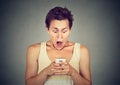 Anxious shocked man looking at phone seeing bad news photos Royalty Free Stock Photo