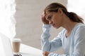 Anxious worker sitting at desk looking at computer screen