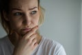 Anxious, worried, stressed young woman looking pensive