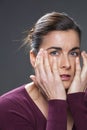 Anxious young brunette woman looking sad