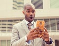 Anxious young business man looking at phone seeing bad news Royalty Free Stock Photo