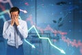 Anxious young businessman covering face with falling forex chart arrows on blurry office interior background. Financial crisis, Royalty Free Stock Photo