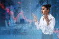 Anxious young businesswoman standing with falling forex chart arrows on blurry office interior background. Financial crisis, trade