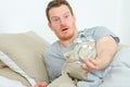 anxious young man looking at alarm clock Royalty Free Stock Photo