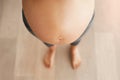 Any day now. Cropped high angle shot of a pregnant womans bare belly. Royalty Free Stock Photo