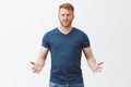 Any problem. Portrait of confused questioned attractive masculine european redhead guy in blue t-shirt, gesturing with