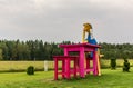 Giant wooden Buratino (Pinocchio) sitting at the table