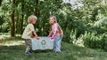 Anything that can be recycled. Two cute little boy and girl holding recycle bin with plastic waste while standing in the Royalty Free Stock Photo