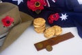 Anzac Day accessories with flag, hat and two-up game.