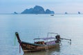 One moored thai long tail boat in sea water is waiting for tourists