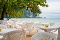 Ao Nang, Thailand: empty tables of an open-air cafe. Summer is the low season in Krabi province so tourist business idles