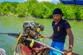 AO NANG, THAILAND - FEBRUARY 09, 2018: Unidentified man manipulating a boat motor of long fisihng boat with a nature