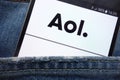 AOL website displayed on smartphone hidden in jeans pocket