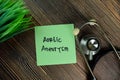 Aortic Aneurysm write on sticky notes isolated on Wooden Table Royalty Free Stock Photo