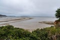 Aotea Harbor during the low tide under a cloudy sky in summer