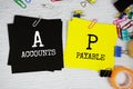 AP - Accounts Payable text on stick note with stationery on concrete background Royalty Free Stock Photo