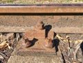 Rusty train railway detail, oiled sleepers and stones between rail way Royalty Free Stock Photo