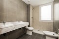 Apartment bathroom with gray and beige tiles with white marble countertop Royalty Free Stock Photo