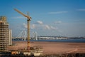 Apartment block under construction and modern suspension bridge spanning the River Neva in St Petersburg, Russia