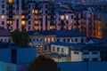 Apartment blocks in the sleeping district at night time. Urban aerial cityscape at dusk, rising electricity prices Royalty Free Stock Photo