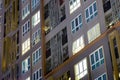 Apartment building complex in the city with condos and soft light glowing from the windows where occupants in well planned