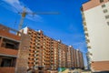 Apartment building construction by crane brick exterior facade architecture shape urban industrial scene