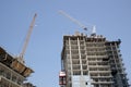 Apartment building with cranes on the construction site Royalty Free Stock Photo