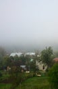 The apartment building is in front of a thick layer of fog. Living in a mountainous area in the Carpathians, Ukraine Royalty Free Stock Photo