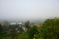 The apartment building is in front of a thick layer of fog. Living in a mountainous area in the Carpathians, Ukraine Royalty Free Stock Photo