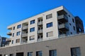 Apartment building with gray facade with blue clear sky in the background