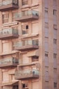 An apartment building with a large number of glass balconies and windows. Royalty Free Stock Photo